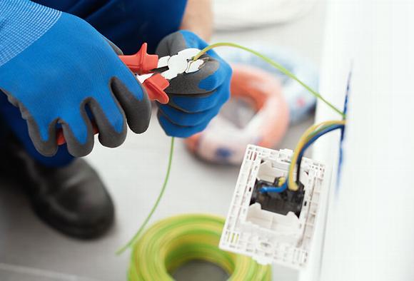 Electrician installing new plug socket