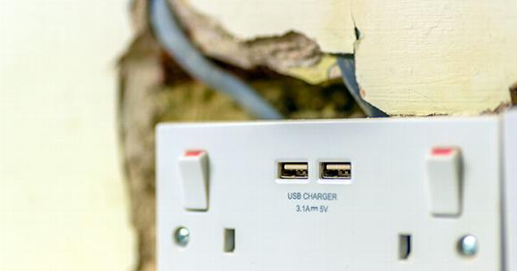 UK plug socket with exposed wiring